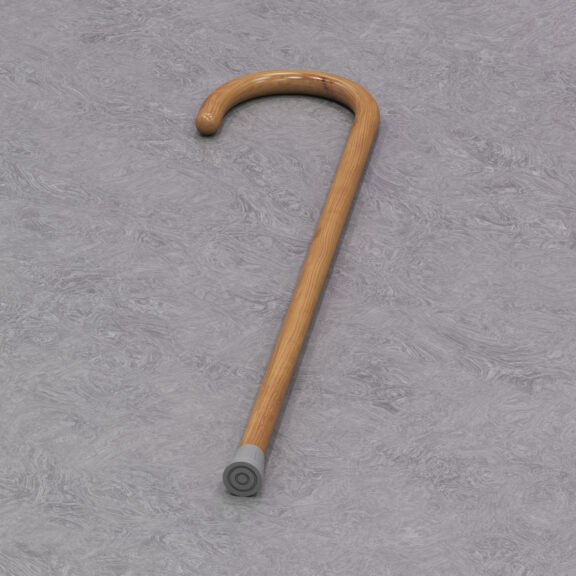 A walking stick lays on grey background