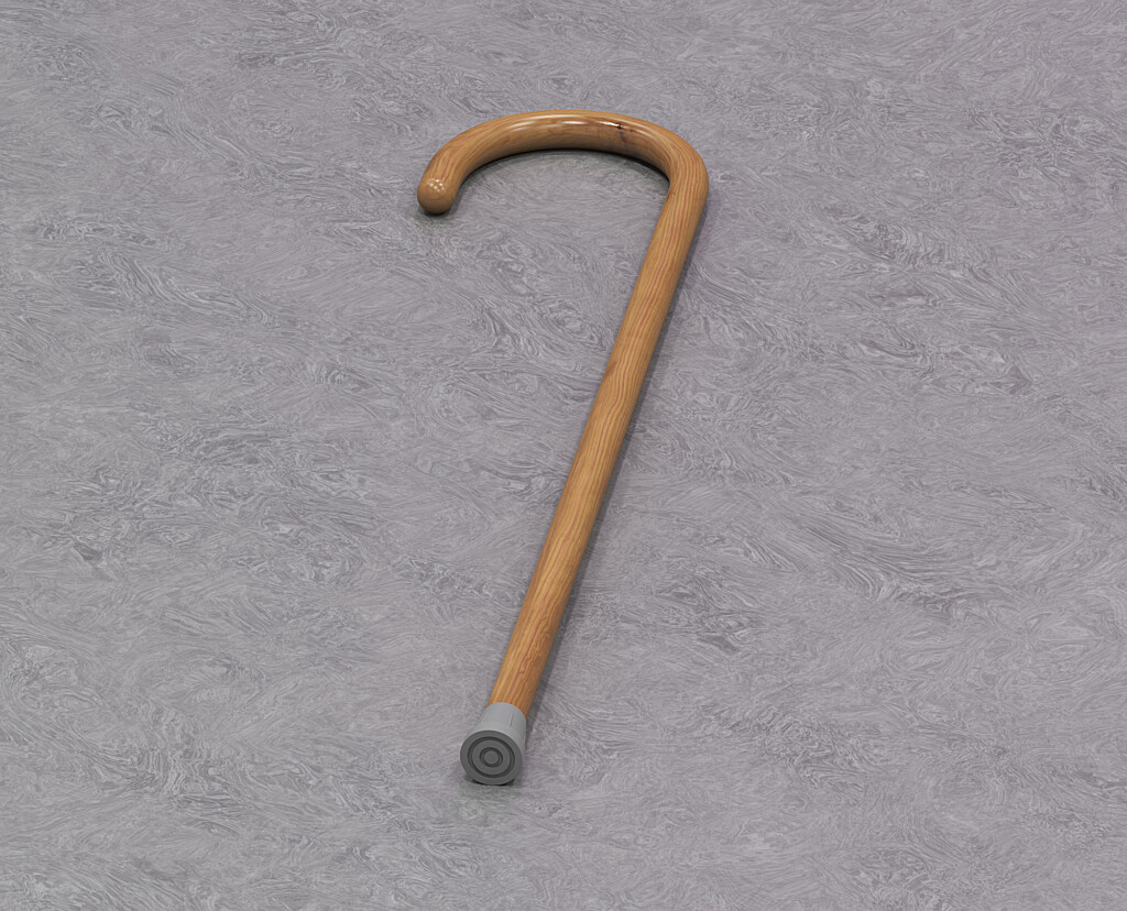 A walking stick lays on grey background