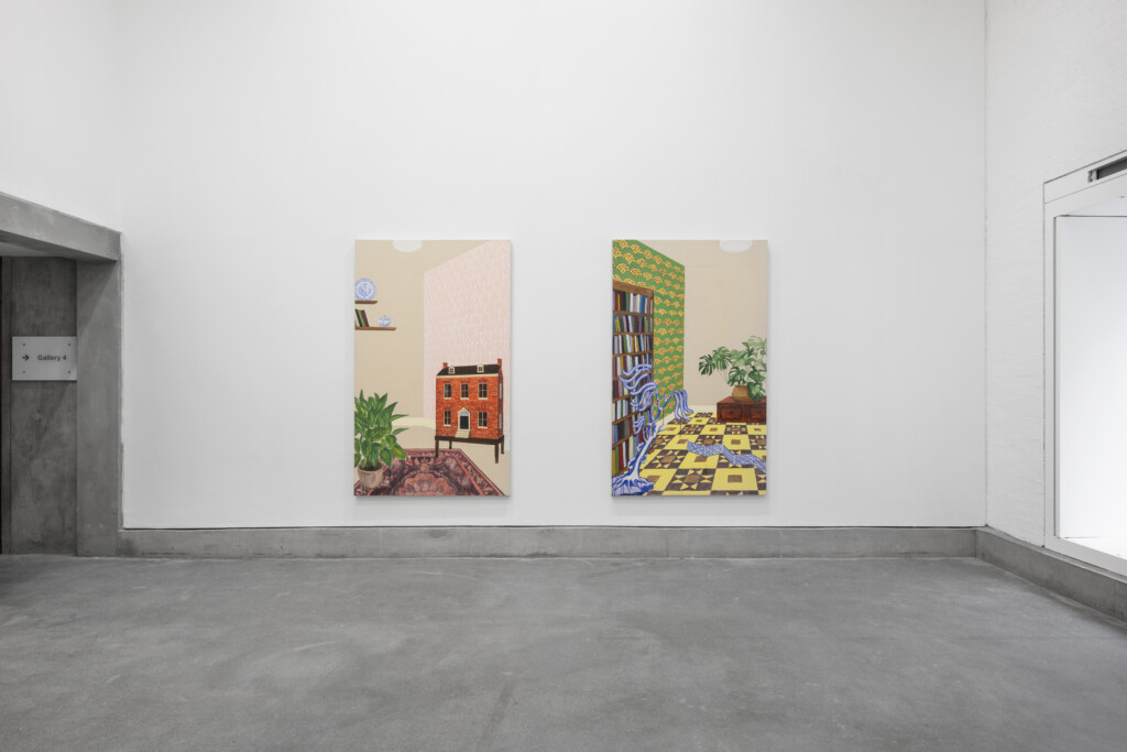 A photograph of the inside of Josie Jenkins' exhibition, Assembled Worlds. The photo shows two interior paintings, one depicting a room with a doll house, and the other a room with a plant and bookshelf.