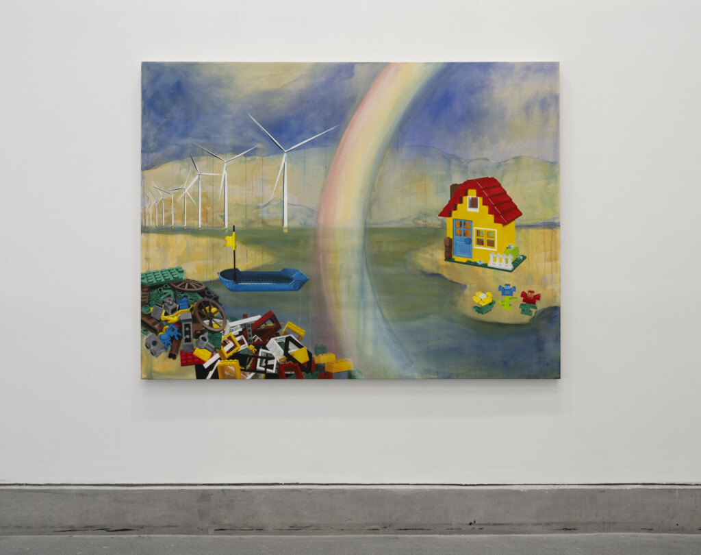 A landscape painting by Josie Jenkins. The landscape depicts a house, flowerbed, and junkyard all made out of children's building blocks, inhabiting a landscape that is done in a fluid watercolour style.