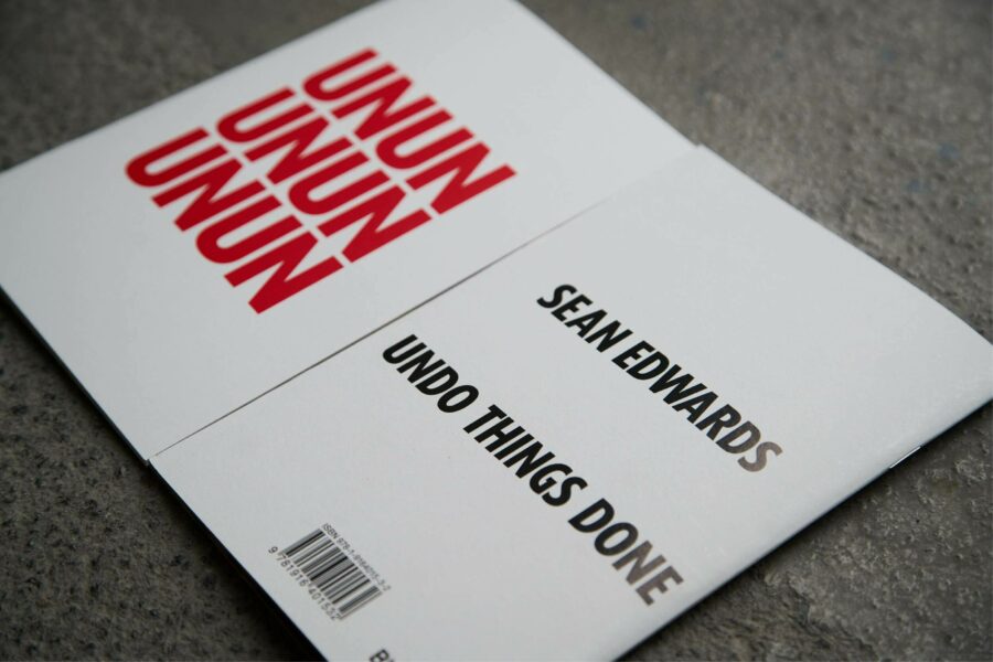 An image of a pamphlet by Sean Edwards, which has the text 'unununununun' in bold red, and 'Sean Edwards Undo Things Done' in black.