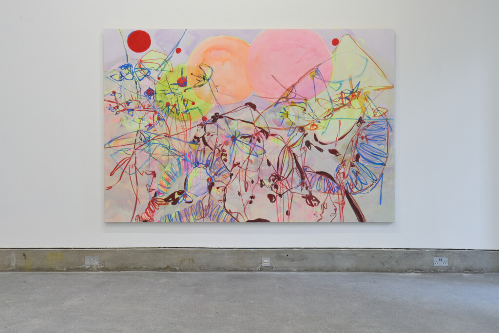 A large painting, consisting of lots of multicoloured splatters and shapes on a canvas.