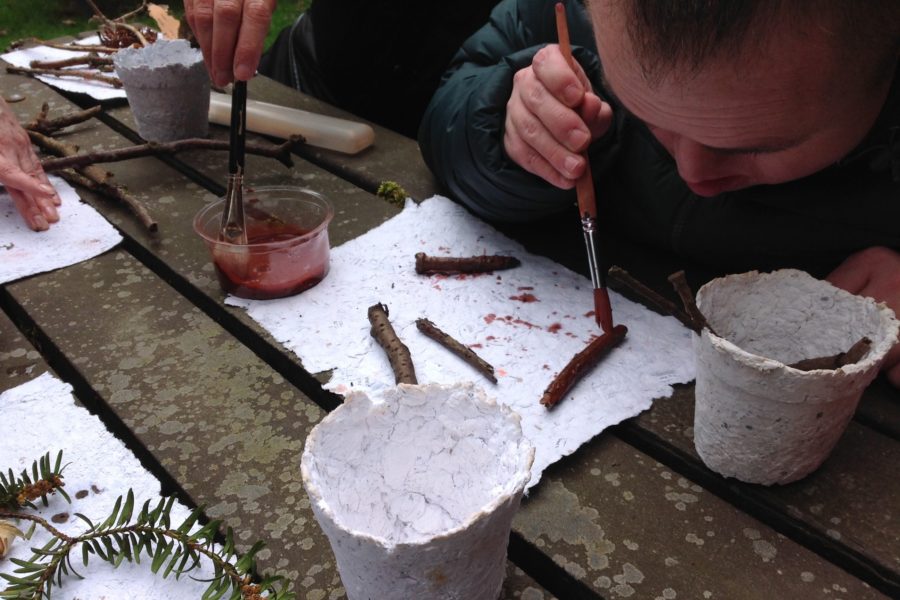 Blue Room member painting twigs