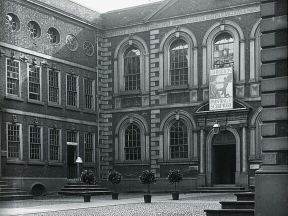 Bluecoat with sign advertising a modern art exhibition