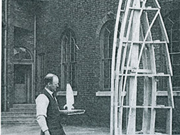 Artist in the Bluecoat yard, holding a maquette for a traffic pylon sculpture