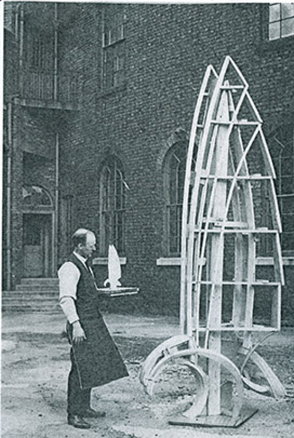 Artist in the Bluecoat yard, holding a maquette for a traffic pylon sculpture