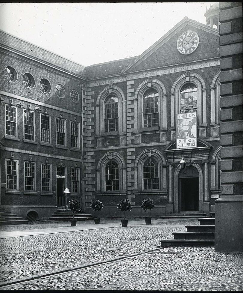 Bluecoat with sign advertising a modern art exhibition